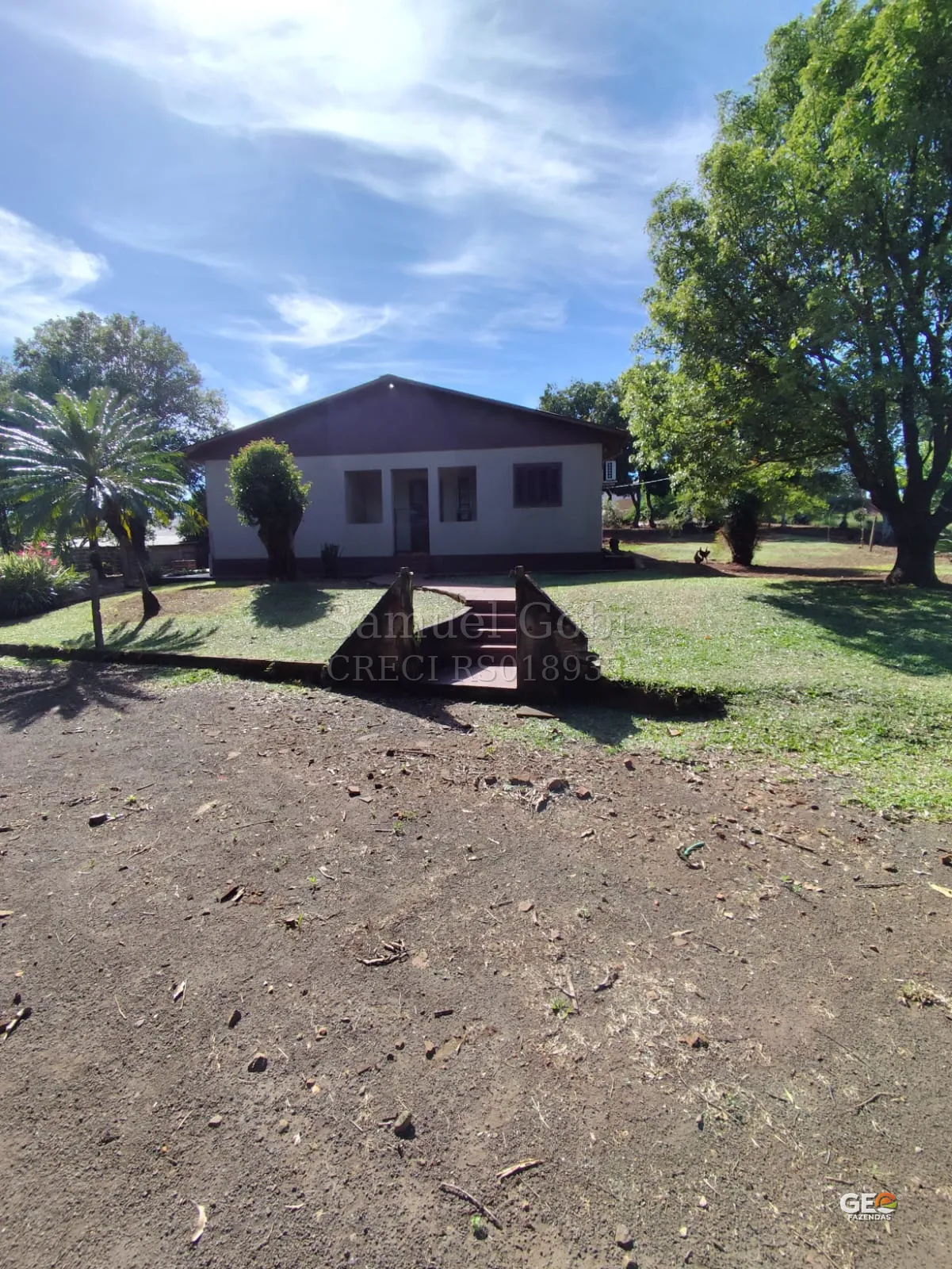 Casa rural com área verde e árvores
